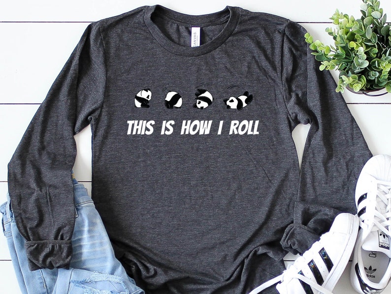 May include: A dark gray long-sleeved t-shirt with a white graphic of five pandas rolling, and the text "This is how I roll".