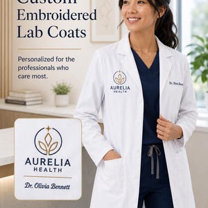 May include: A white lab coat featuring custom embroidery with the text Aurelia Health and Dr. Olivia Bennett. The coat has a notched lapel, front buttons, and two large patch pockets. A close-up inset shows the logo and name in navy and gold.