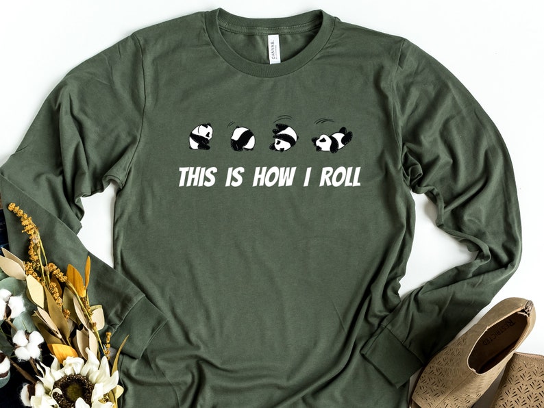 May include: A green long-sleeved t-shirt with a graphic of five pandas rolling, and the text "This is how I roll".