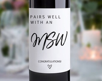 May include: A white wine bottle label with black text that reads "Pairs well with an MSW. Congratulations!" with a small heart symbol.