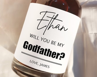 May include: A white label with black text on a brown glass bottle. The label reads "Ethan, Will you be my Godfather? Love, James".