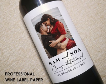May include: A personalised wine bottle label featuring a photograph of a couple embracing. The label includes the text "SAM and NOA Congratulations!" and the date "NOVEMBER 09 | 2022".