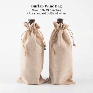 May include: Two beige burlap wine bags with drawstring closures. The bags are designed to fit a standard wine bottle. The text "Burlap Wine Bag" is at the top of the image, with the size listed as 5.9 x 13.8 inches.