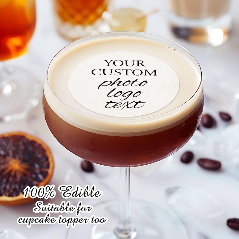 May include: A white round edible cake topper with the text "YOUR CUSTOM photo logo text" on top of a brown cocktail in a martini glass. The text "100% Edible Suitable for cupcake topper too" is below the glass.