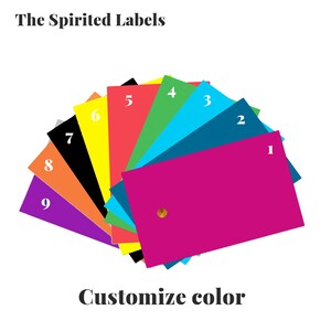 May include: A color chart with nine different color swatches, numbered 1 through 9. The swatches are arranged in a fan shape, with the largest swatch at the bottom. The colors are: purple, orange, black, yellow, red, green, blue, teal, and magenta. The text "The Spirited Labels" is at the top of the image, and the text "Customize color" is at the bottom.