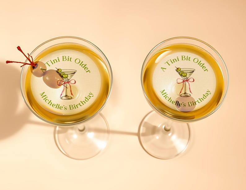 May include: Two martini glasses with a sticker on each that says "A Tini Bit Older Michelle's Birthday" with a martini glass and olives on the sticker.