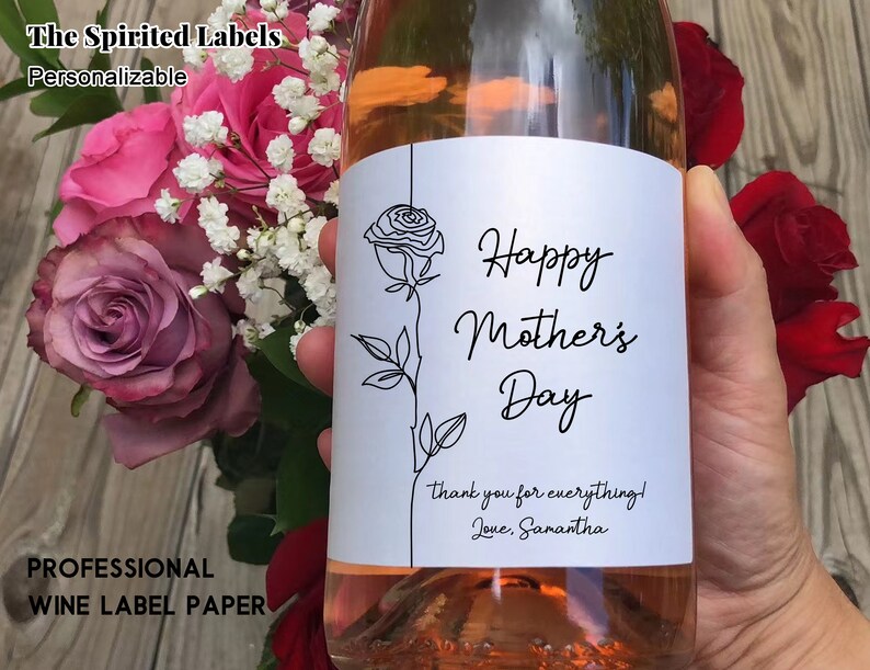 May include: A white wine bottle label with a black line drawing of a rose and the text "Happy Mother's Day" with a thank you message below.