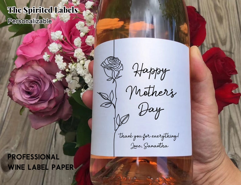 May include: A white wine bottle label with a black line drawing of a rose and the text "Happy Mother's Day" with a thank you message below.