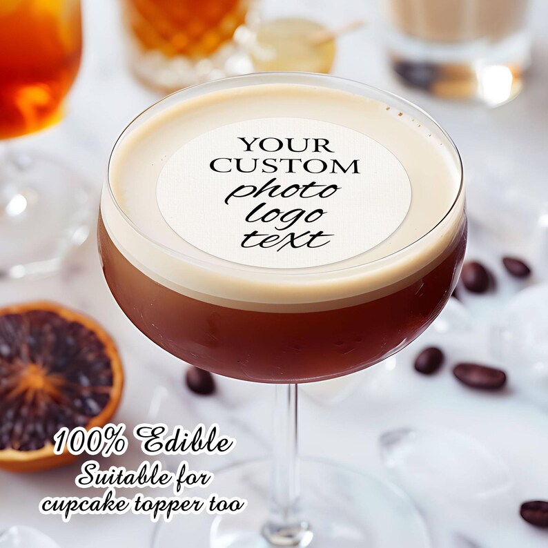 May include: A white round edible cake topper with the text "YOUR CUSTOM photo logo text" on top of a brown cocktail in a martini glass. The text "100% Edible Suitable for cupcake topper too" is below the glass.