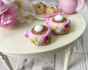 A miniature set of 2 decorative floral mugs with 2 hot cross buns