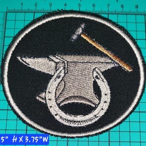 May include: A round black patch with a white border featuring a blacksmith's anvil, horseshoe, and hammer design. The patch measures 3.5 inches high by 3.75 inches wide.