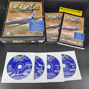 May include: A boxed copy of the computer game Fly! 2K Special Edition, featuring a blue and red box with a picture of a plane on the front. The box includes four CDs, a quick reference guide, and a user manual.