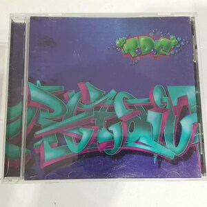 May include: A clear plastic CD jewel case featuring a purple cover with teal and magenta graffiti-style lettering. The text TDC is printed in the upper right corner in a bubble font with small circular accents in shades of green and purple.