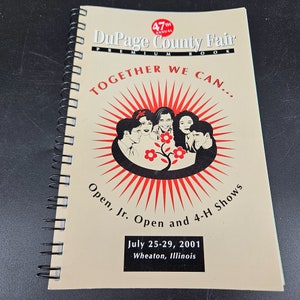 May include: A tan booklet with a red and black sunburst design. The text "47th Annual DuPage County Fair Premium Book" is at the top. The text "Together We Can..." is in a large font below the sunburst. The text "Open, Jr. Open and 4-H Shows" is below the sunburst. The text "July 25-29, 2001 Wheaton, Illinois" is at the bottom.