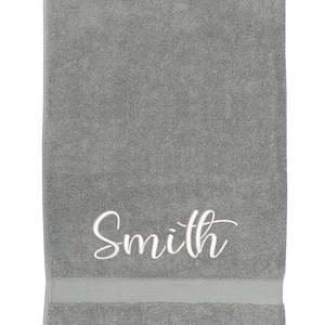 May include: Gray bath towel with the name "Smith" embroidered in white.