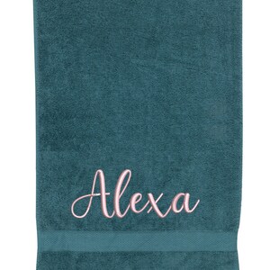 May include: A teal blue bath towel with the name "Alexa" embroidered in pink.