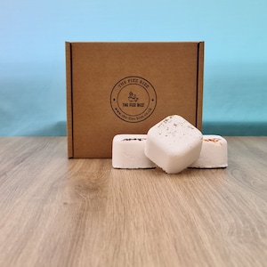 3 of our shower steamers (Hangover, Anti-Anxiety, and Kick Start) artfully arranged in front of their presentation box. For information on their scents refer to scent page. For information on their size use the dimension page.