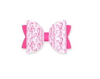 May include: A pink bow with a white background featuring a pink ribbon pattern.