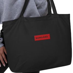 May include: A black tote bag with a red rectangle and the text "BAMILEKE." printed in black.