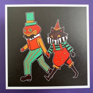May include: A black cat wearing a red and green jester costume with a white collar and teeth, and a pumpkin wearing a green hat and a red and green striped shirt, on a black background.