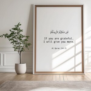 May include: A framed print with a white background and black text in Arabic and English. The text reads "If you are grateful, I will give you more. Al Quran [14:7]"