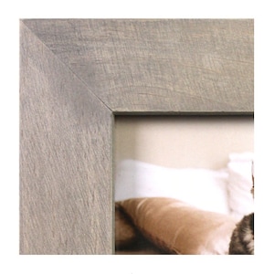 May include: A close-up of the corner of a gray wood picture frame. The frame has a rustic, weathered look.