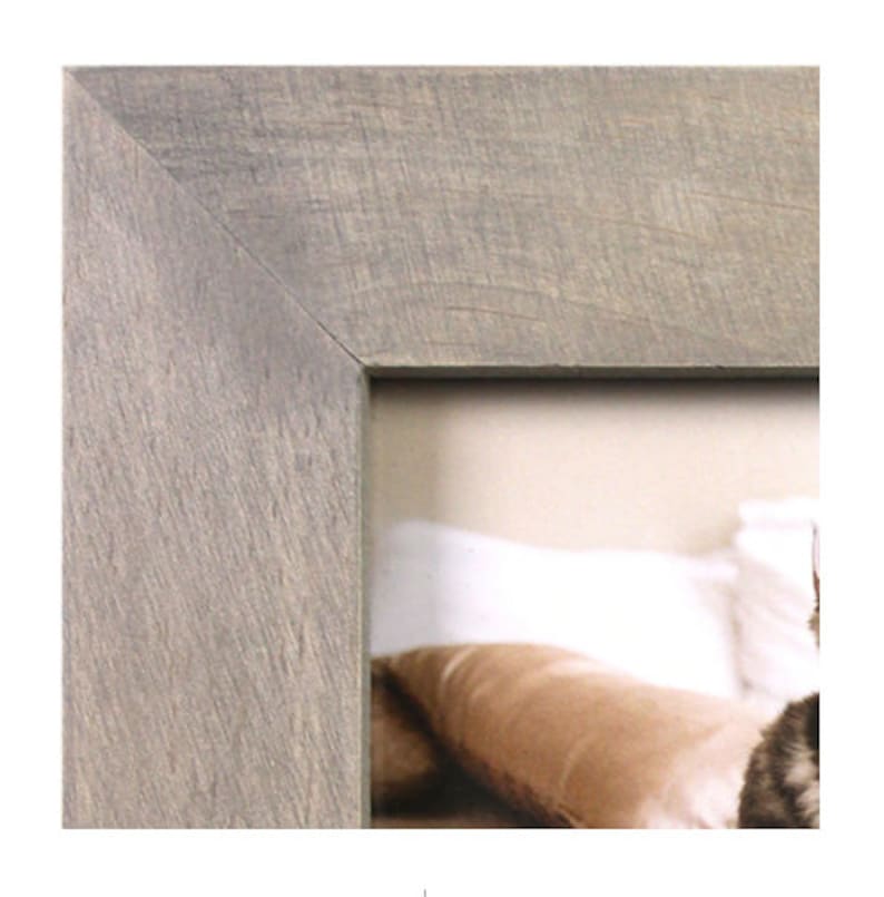 May include: A close-up of the corner of a gray wood picture frame. The frame has a rustic, weathered look.