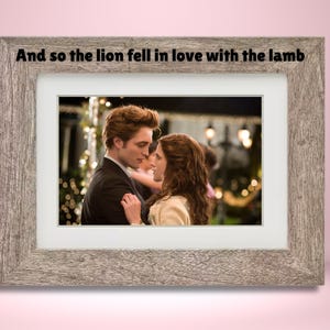 May include: A framed photograph of a couple dancing at a formal event. The text "And so the lion fell in love with the lamb" is printed above the image.
