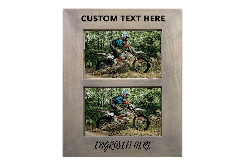 May include: A gray wooden picture frame with two openings for photos. The frame has the text "CUSTOM TEXT HERE" at the top and "ENGRAVED HERE" at the bottom. The photos show a person riding a dirt bike in a wooded area.