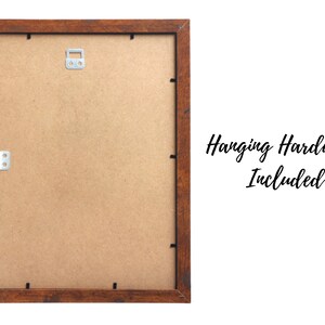 May include: A brown wooden picture frame with a light brown mat. The frame has hanging hardware included.