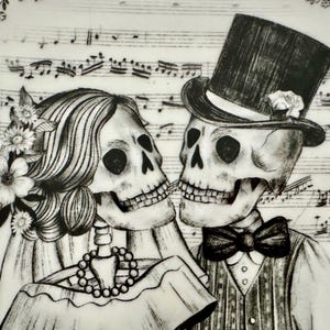 May include: Black and white illustration of a skeleton couple, the bride wearing a veil and flowers, the groom in a top hat and bow tie. Musical notes are in the background, creating a romantic, yet spooky theme.