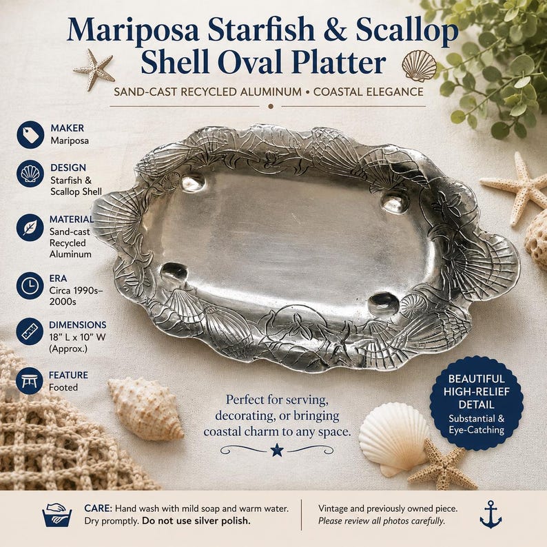 May include: An oval sand-cast recycled aluminum platter featuring a raised relief design of starfish and scallop shells. The platter is footed and measures 18 inches long by 10 inches wide. The text reads Mariposa Starfish & Scallop Shell Oval Platter.