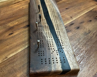 Cribbage board handcrafted with black walnut and pure black epoxy resin, includes metal pegs with storage, for 2 or 3 players