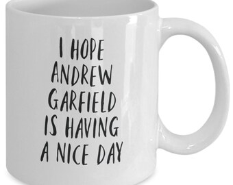 May include: White ceramic coffee mug with black text that reads "I hope Andrew Garfield is having a nice day."