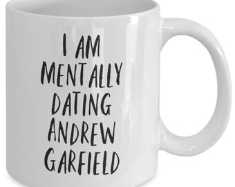 May include: White ceramic coffee mug with black text that reads "I am mentally dating Andrew Garfield".