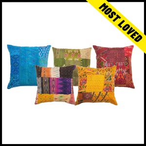 May include: Five decorative throw pillows with patchwork designs. The pillows feature a variety of colors, including blue, green, red, yellow, and purple. Each pillow has a unique pattern and texture, adding visual interest to any space.