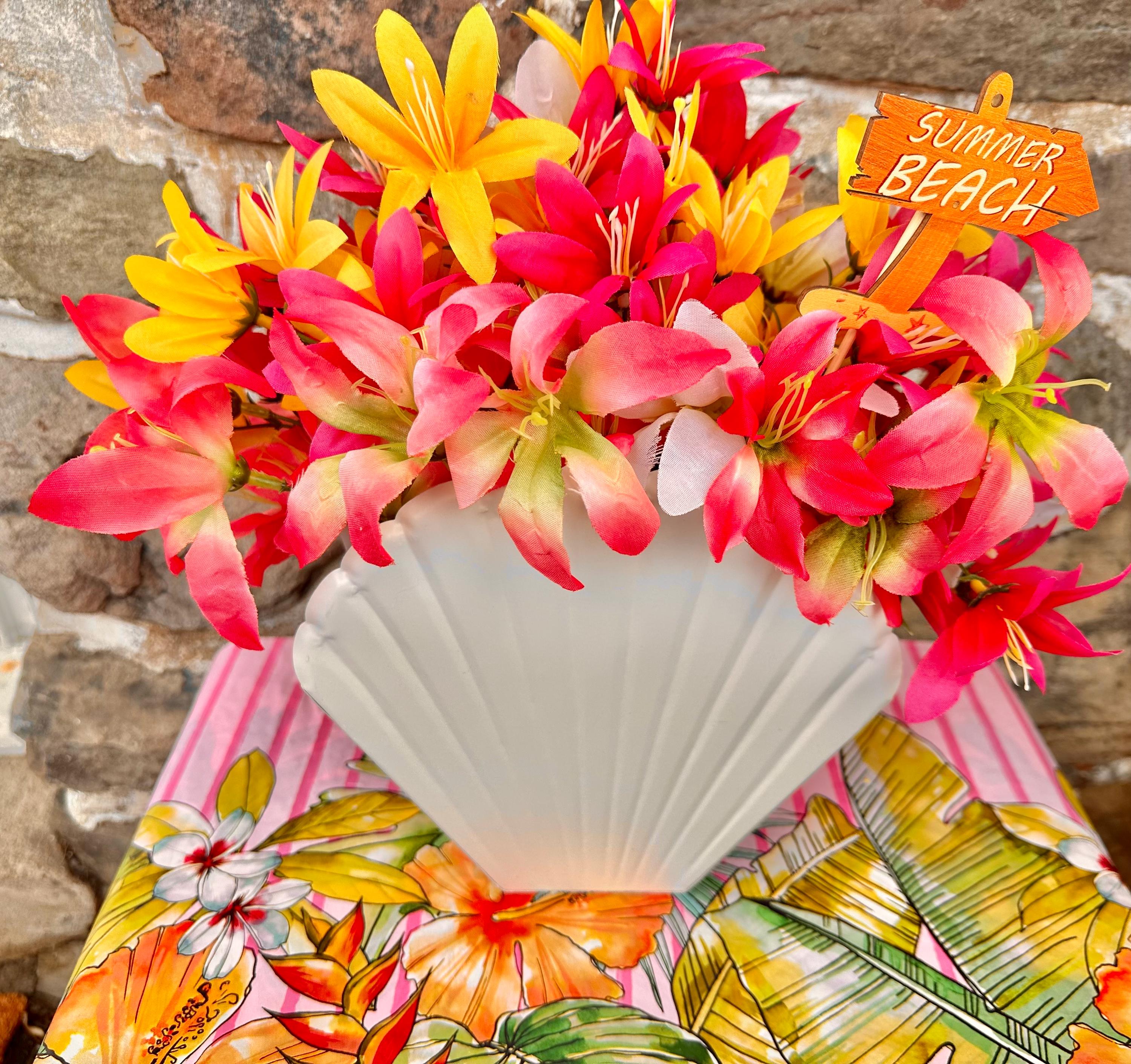 Colorful Tropical Flowers in a White Seashell Vase