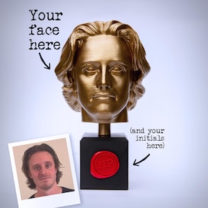 May include: A gold-coloured bust of a person with shoulder-length hair mounted on a black square base. A red wax seal with the letters NP is attached to the front of the base. Text on the image reads Your face here and and your initials here.