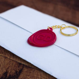 A red seal keyring on a folded task