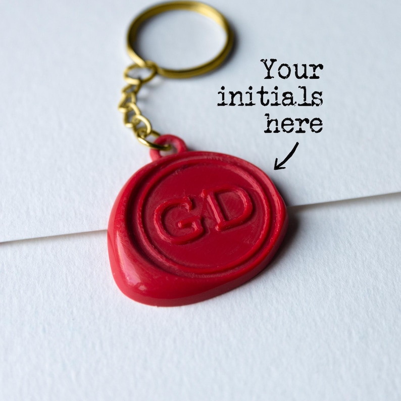 Red wax seal keyring in the style of Taskmaster with the initials GD and text Your initials here