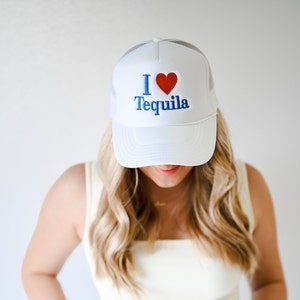 May include: White trucker hat with a red heart and blue embroidery that says "I love Tequila".