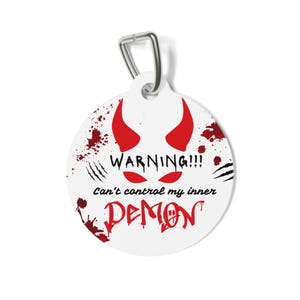 May include: Round white tag with a red devil's horns and eyes, blood splatter, and the text "WARNING!! Can't control my inner DEMON".