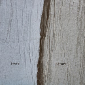 May include: Close-up of two fabric swatches, one ivory and one brown. The ivory swatch is labeled "Ivory" and the brown swatch is labeled "Nature".