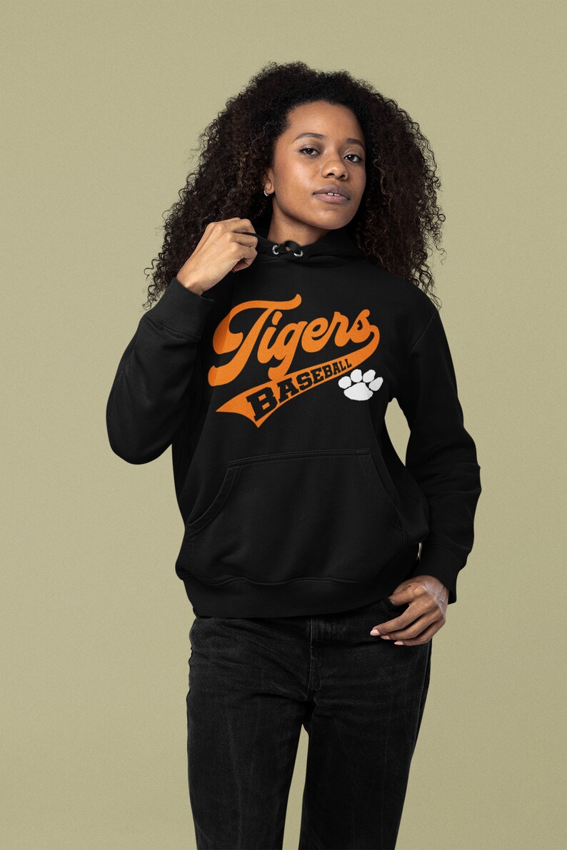 May include: Black hooded sweatshirt with an orange graphic that says "Tigers Baseball" with a white paw print.