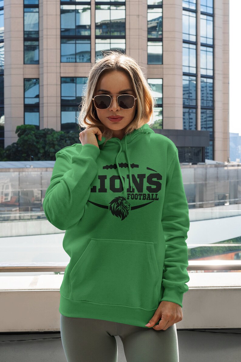 May include: Green hooded sweatshirt with a black lion graphic and the text "Lions Football".