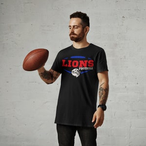 May include: A black t-shirt with a graphic of a football and the text "LIONS FOOTBALL" in red, blue, and white.