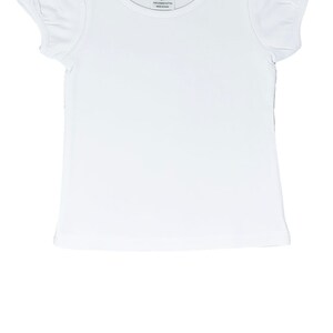 May include: A white short-sleeved t-shirt with a round neckline and puffed sleeves. The tag reads "A.J. Blanks 2T". The shirt is made of 100% cotton and is made in China. This shirt is perfect for children.