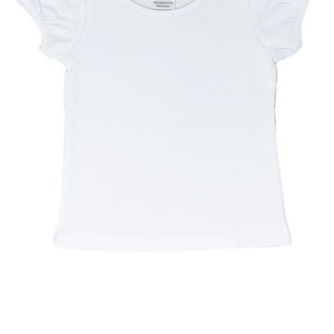 May include: A white short-sleeved t-shirt with a round neckline and puffed sleeves. The tag reads "A.J. Blanks 2T". The shirt is made of 100% cotton and is made in China. This shirt is perfect for children.