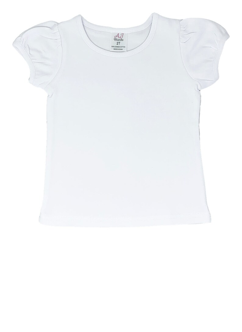 Op de afbeelding: Een wit T-shirt met korte mouwen, een ronde hals en pofmouwen. Het label luidt "A.J. Blanks 2T". Het shirt is gemaakt van 100% katoen en is gemaakt in China. Dit shirt is perfect voor kinderen.