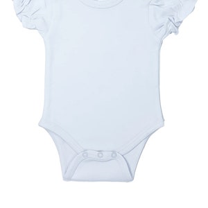 May include: A light blue baby bodysuit with short, ruffled sleeves. The bodysuit has snap closures at the bottom and on the shoulder. A small tag on the neckline reads "AJ Blanks 3-6M".
